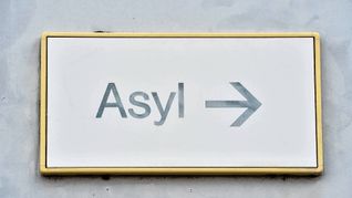 Ein Schild mit der Aufschrift "Asyl" in einer Erstaufnahme für Asylbewerber.