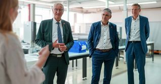 Landrat Roland Bernhard, Bürgermeister Ioannis Delakos und Binder-Geschäftsführer Patrick Geffers (von links) hören interessiert zu.
